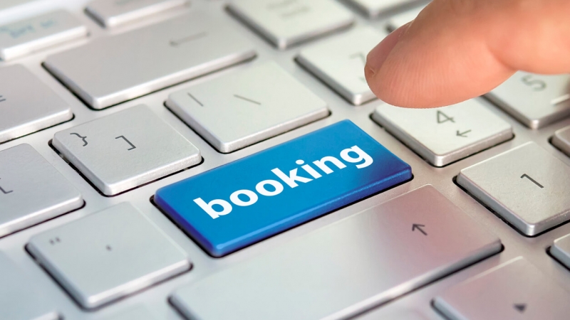person pressing booking button to book hotel